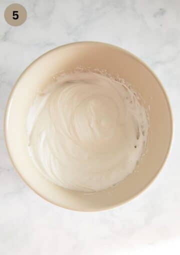 stiff egg whites in a bowl.