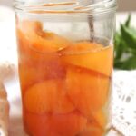 tall jar with preserved apricots.