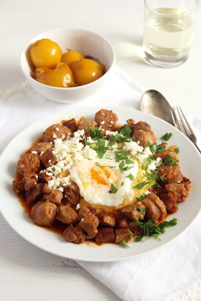 sausage stew with fried eggs and polenta