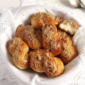 romanian yeast pastries mucenici in a basket lined with a vintage cloth.