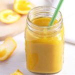 apple orange smoothie with turmeric and orange juice in a jar.