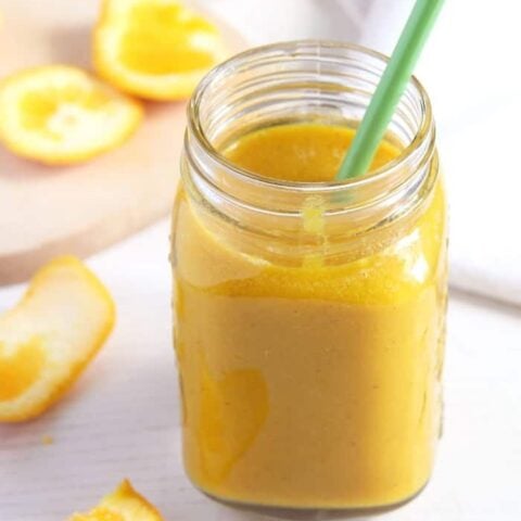 apple orange smoothie with turmeric and orange juice in a jar
