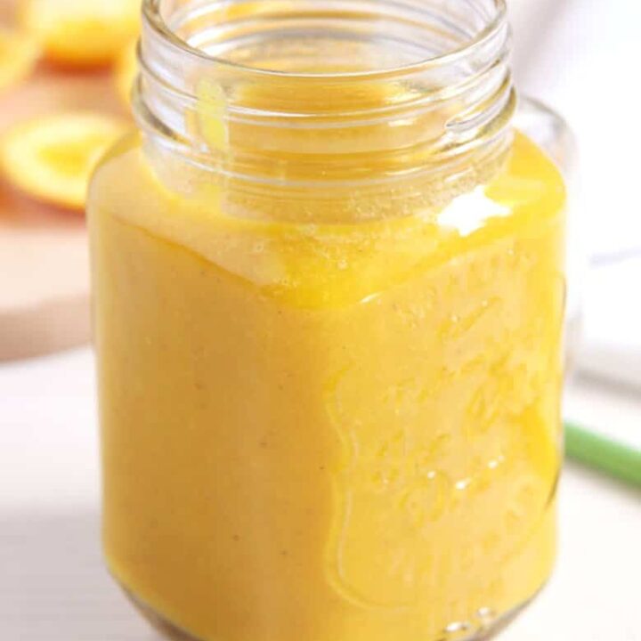 apple orange banana smoothie with turmeric in a jar