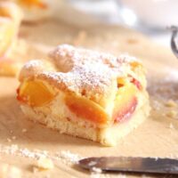 slice of nectarine cake sprinkled with icing sugar