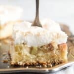 pinterest image with title for rhubarb meringue cake.