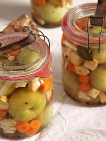 jars with green pickled tomatoes