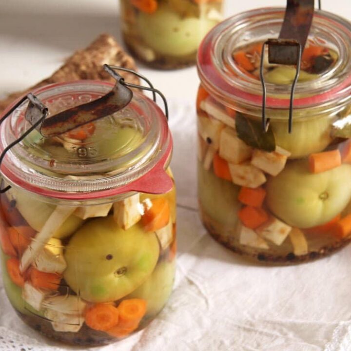 jars with green pickled tomatoes