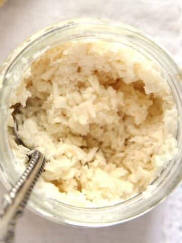 prepared horseradish in a jar with a spoon.