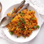 turmeric cabbage stew on a plate with fork and spoon