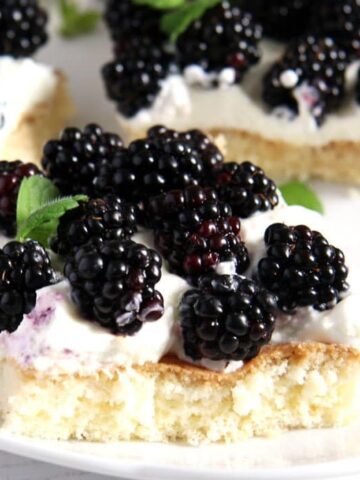 slice of cake topped with jewelled-like fresh blackberries