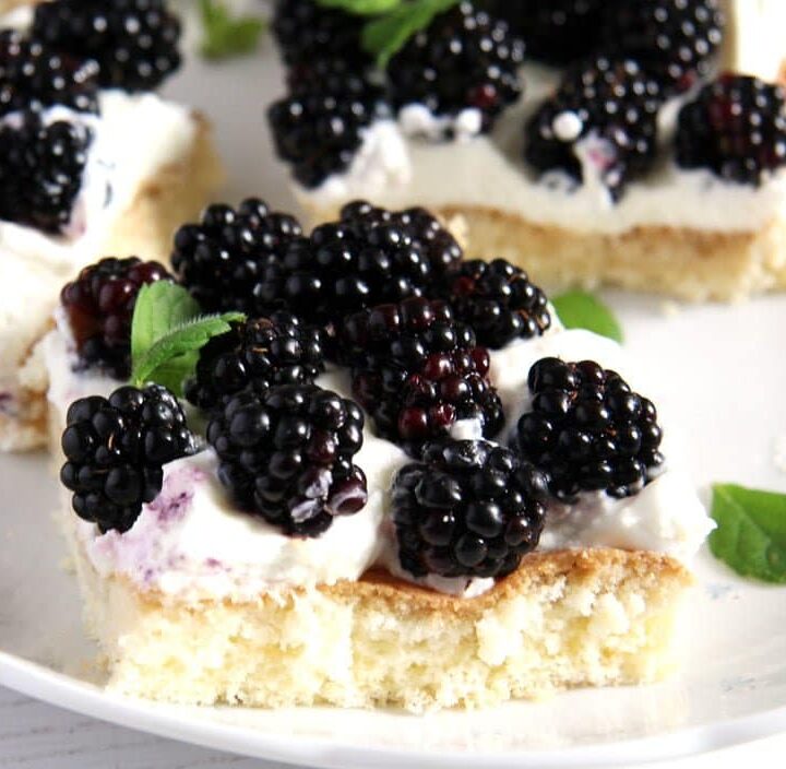slice of cake topped with jewelled-like fresh blackberries