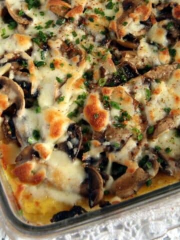 mushroom polenta casserole with golden cheese on top.