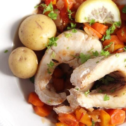 plate with fish, vegetables and whole potatoes