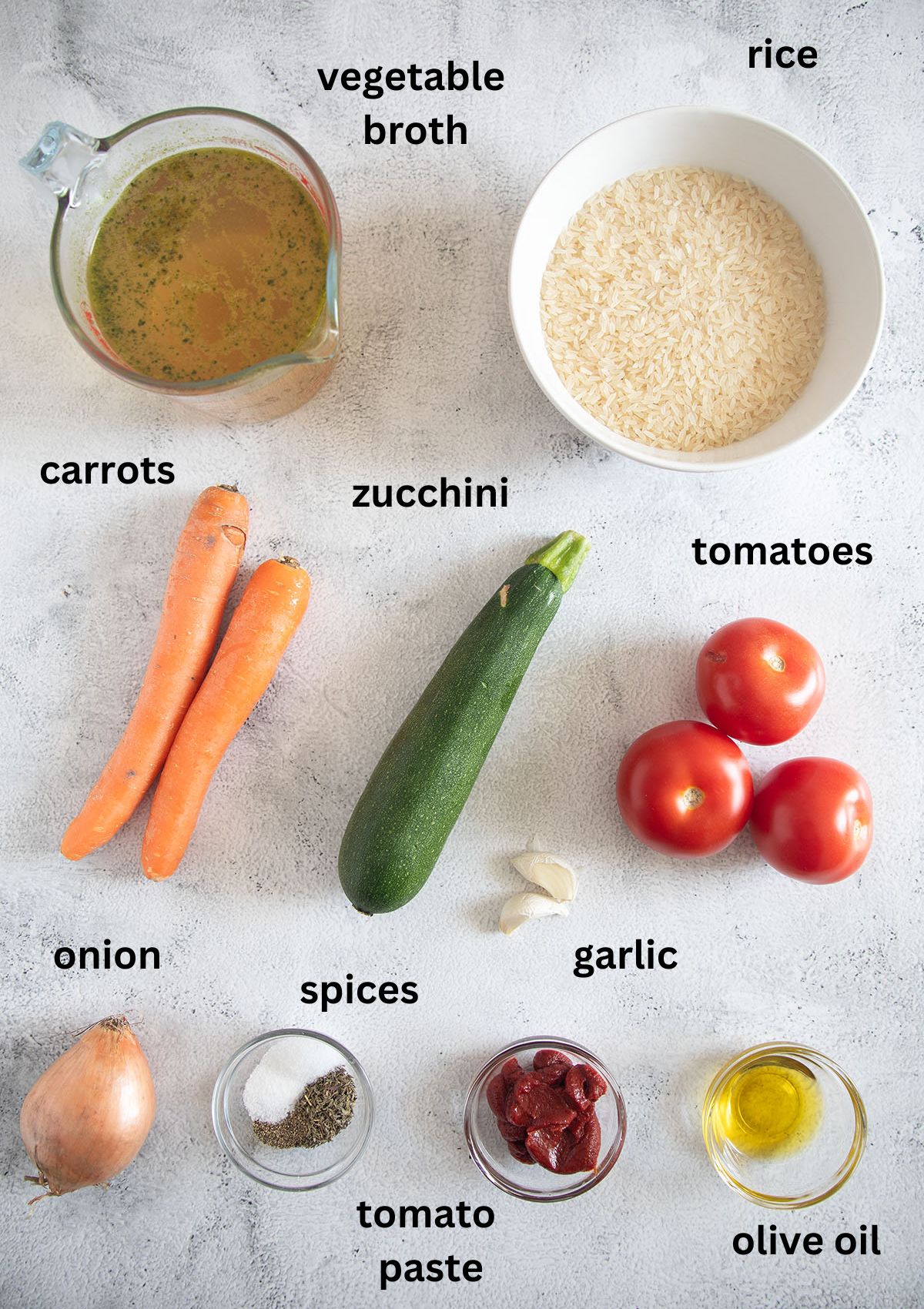 labeled ingredients for making rice with zucchini, carrots, and tomatoes.