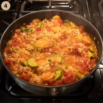 simmering pot with rice and vegetables.