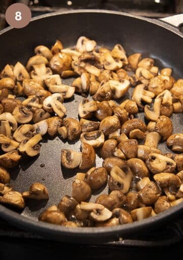 sauteing mushrooms in a large pan.