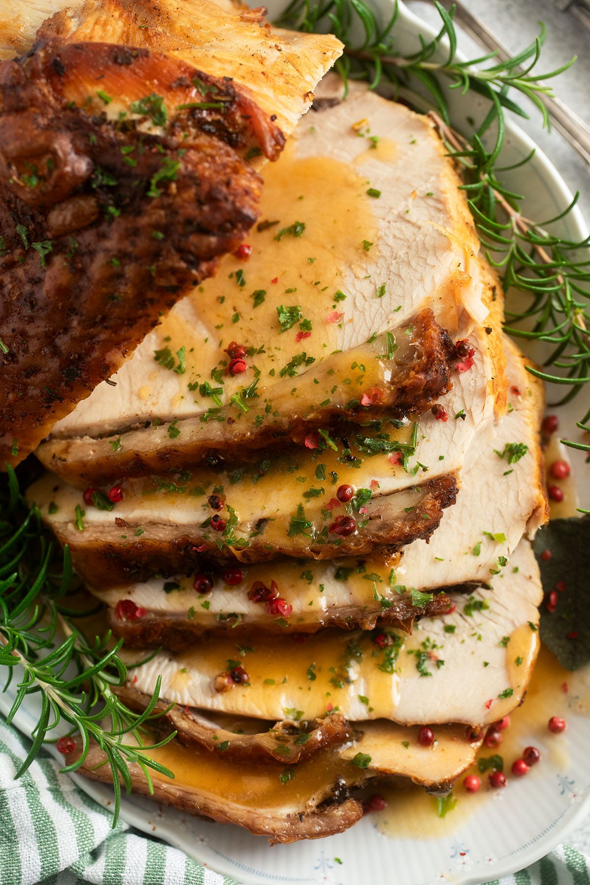 sliced turkey breast with gravy on a platter.