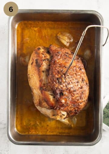a slow-roasted turkey breast with a meat thermometer sticking into it.