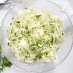 white cabbage salad sprinkled with fresh chopped parsley in a vintage bowl.