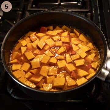 adding raw pumpkin cubes to pot to stew them with spices and water.