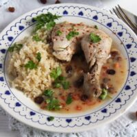 Poached Chicken in White Sauce with Raisins and Rice