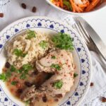 poached chicken thighs in white sauce served with rice