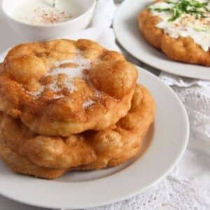 two hungarian langos with sugar and one with sour cream.