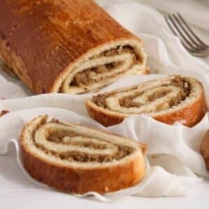 hungarian nut roll sliced on a white cloth.