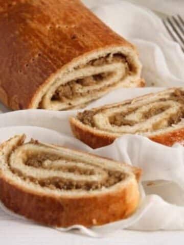 hungarian nut roll sliced on a white cloth.