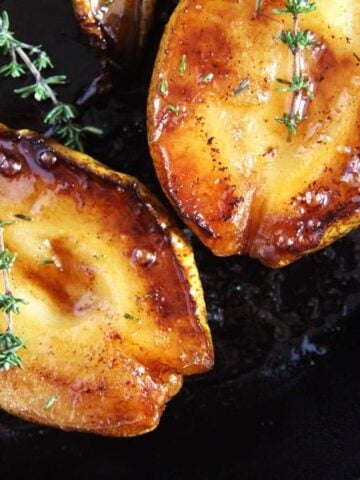 shiny roasted pears halves in skillet