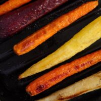 roasted whole carrots on a baking sheet.