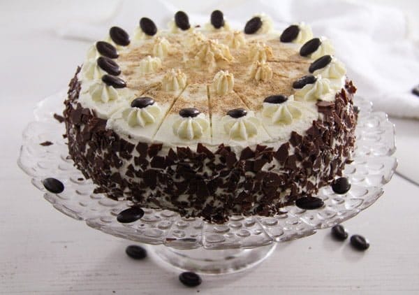 whiskey cake decorated with chocolate and whipped cream