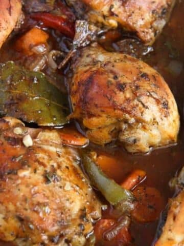 roasted chicken and vegetables with sauce close up.