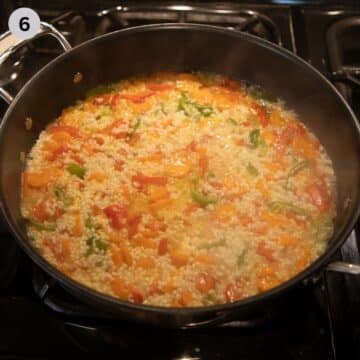 simmering rice pilaf in a large saucepan on the stovetop.