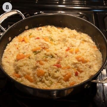 romanian pilaf with chicken and vegetables in a saucepan on the stovetop.