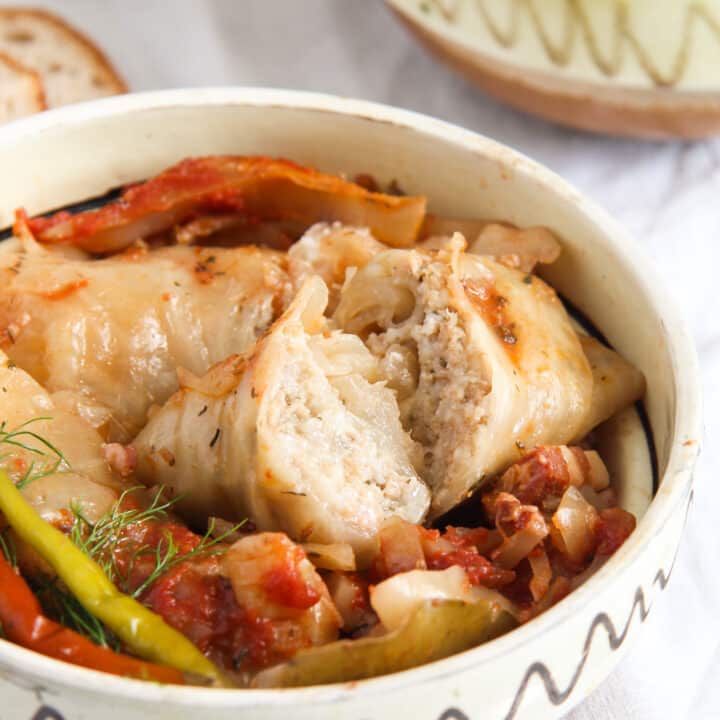 split romanian stuffed cabbage in a rustic bowl.