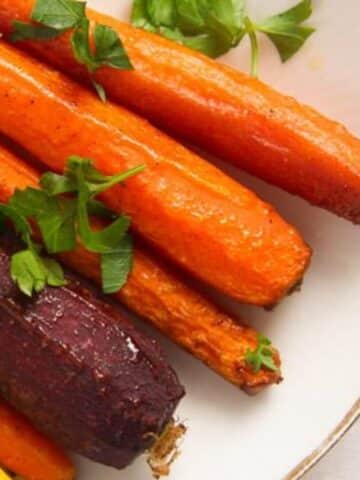 close up of rainbow colored whole roasted carrots.