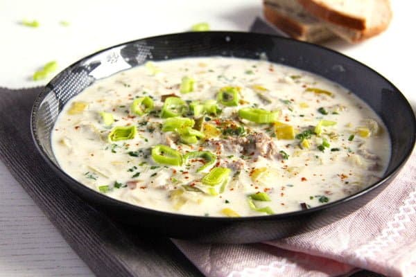 bowl with creamy cheese cheese soup with pork and leeks.