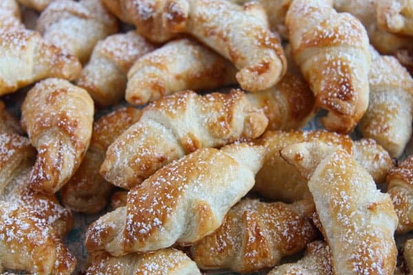 croissants with jam sprinkled with icing sugar close up