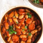pot with bean stew and sausages