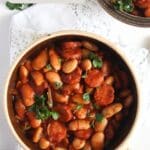 pinterest image with the title polish sausage and bean stew.