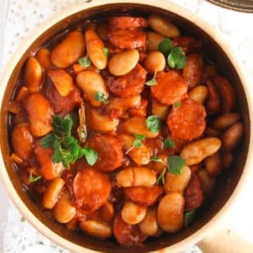 polish sausage stew with large white beans in a pot.