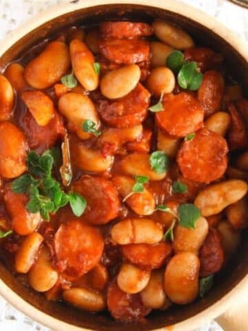 polish sausage stew with large white beans in a pot.
