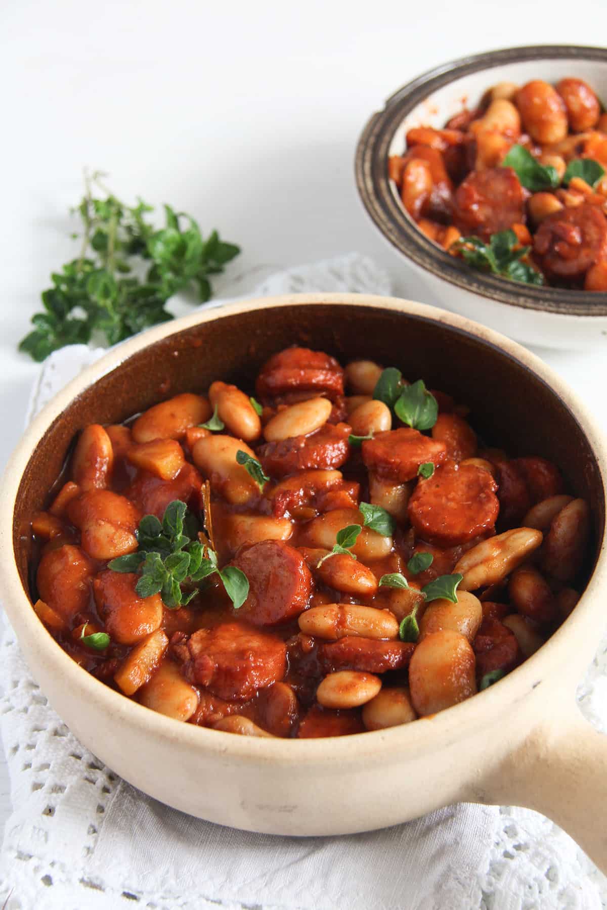 polish sausage stew with beans sprinkled with parsley.