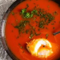 close up overhead picture of a bowl of soup with egg.