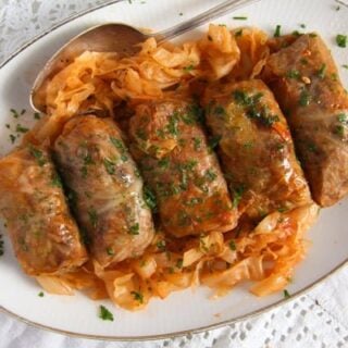 five sour cabbage rolls on a large serving platter