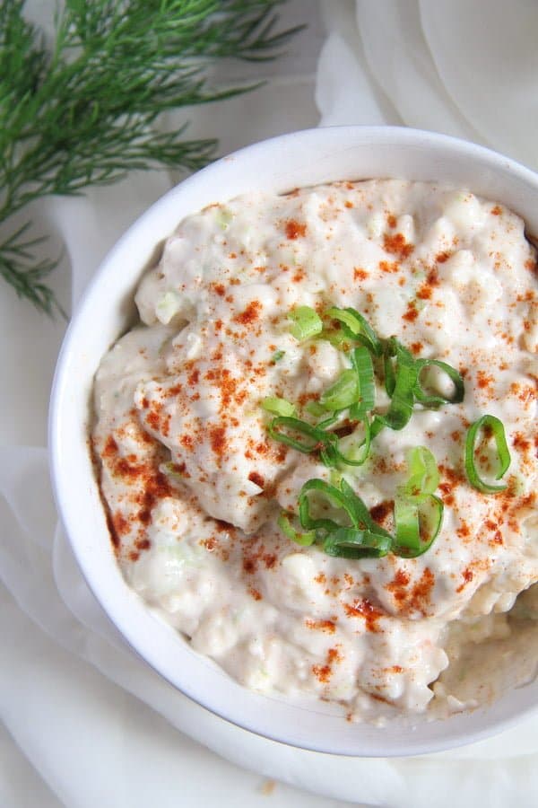 german obatzda in a white bowl with onions and paprika