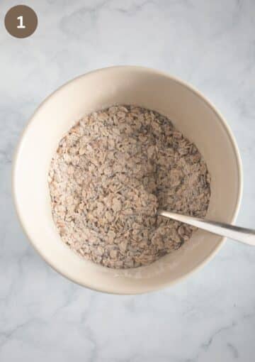 mixing rolled oats, flour and seeds in a bowl to make crispbread.