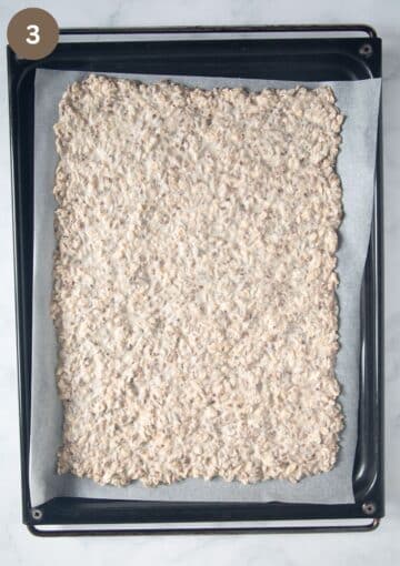 unbaked crispbread mixture spread on a lined baking sheet.