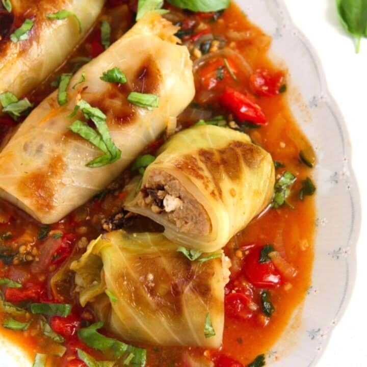 meatless stuffed cabbage rolls served with tomato sauce.